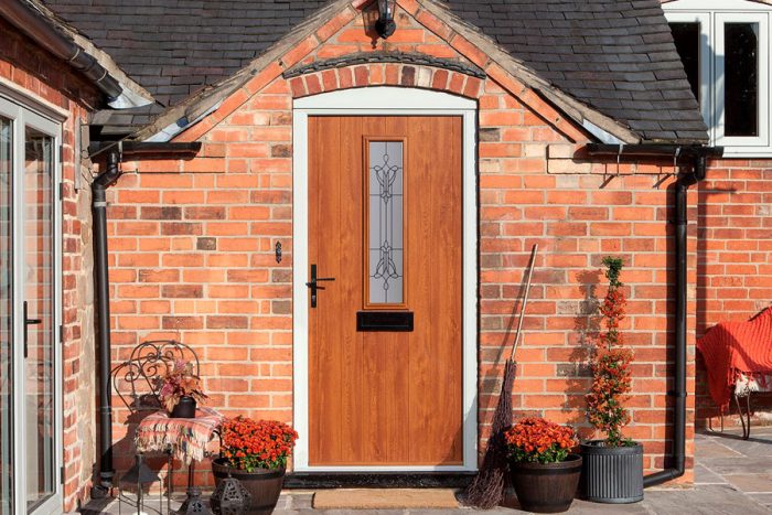 Oak colour composite door with traditional style handle and letterbox